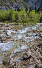 The rushing stream of the Gega river in springtime flows along a rocky riverbed. Abkhazia, near Gega Waterfall. Scenic destination, about 530 m about sea level. Travel, tourism, nature conservation.