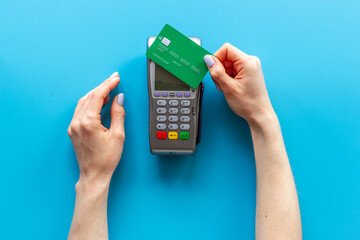 Hand swiping credit card by pos terminal. Payment transactions concept