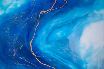 Part of original resin art, epoxy resin painting. Marble texture. Fluid art for modern banners, ethereal graphic design. Abstract ethereal gold, bronze, blue and white swirl.