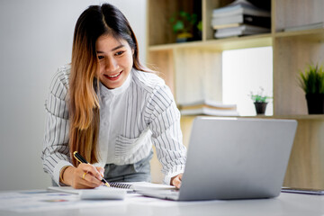 Business achievement concept with happy young business woman working on laptop in office or home, do math report finance tax, accounting, statistics and analytical research.