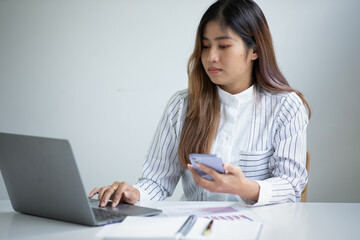 Business achievement concept with happy young business woman working on laptop in office or home, do math report finance tax, accounting, statistics and analytical research.