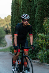 Obraz premium Young Caucasian cyclist riding a bicycle standing upright