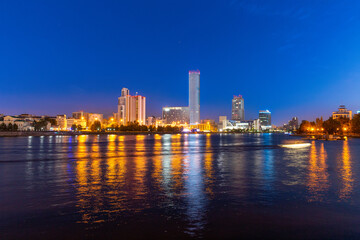 Night view of the skyscrapers of the city of Yekaterinburg. Russia. Reflection in the river