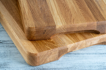 Two wooden cutting board on white wooden table background