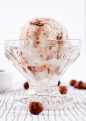 Chocolate ice cream in a glass with ingredients used to decorate the background