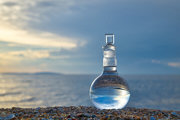 Glass flask by the sea.