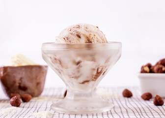 Powdered milk ice cream with chocolate in a glass with ingredients used to decorate the background