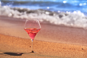 Wine glass with a cocktail by the sea.