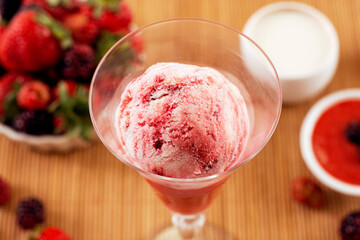 ice cream flavored red fruits in the bowl with ingredients in the decoration