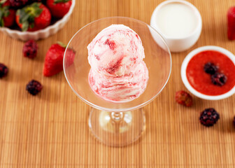 ice cream flavored red fruits in the bowl with ingredients in the decoration