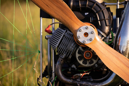 Close-up of a gasoline-powered paraglider in the evening sun. Paraglider for individual flights. Equipment maintenance and safety. Extreme sports.