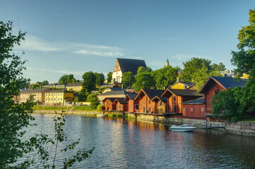 1800 19th century style red fishermen's harbor warehouses in Porvoo Finland with Church background