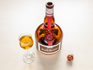 MOSCOW, RUSSIA - JUNE 10, 2021: glass with Grand Marnier Cordon Rougen orange-flavored liqueur created in 1880 by Alexandre Marnier-Lapostolle. It is made from of Cognac brandy, bitter orange, sugar