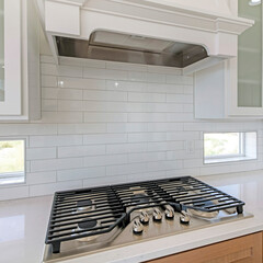 Square frame White kitchen counter with built-in gas cooktop with griddle in stainless steel