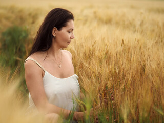 Portrait of young pretty woman without bra in barley field