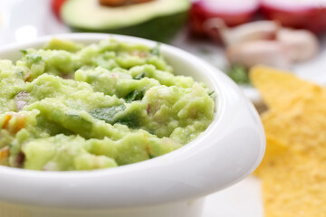 Bowl with tasty guacamole, closeup