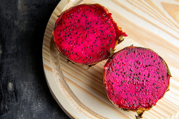pitaya fruit leaning on a wooden table