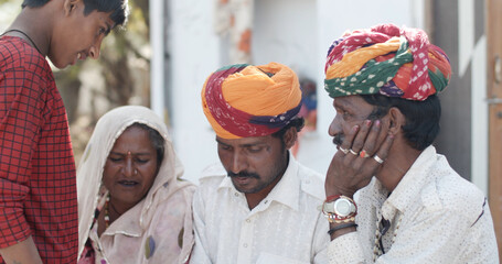 Group of South Asian people in traditional Indian clothing having a discussion