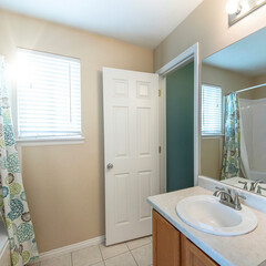 Square frame Interior of a bathroom with ceramic tile flooring and window