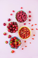Fototapeta na wymiar Strawberry,cherry,raspberry berries in bowls