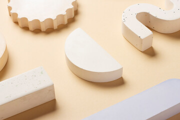 Composition of plaster decorations of different geometries on a delicate background