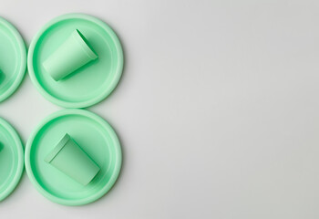 Plastic dishes in mint color on white background
