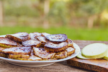 Home made  organic fried zucchini with  garlic yogurt sauce on wooden background