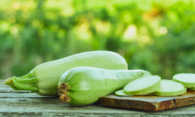 Fresh sliced raw bio zucchini and dill on wooden background. Cooking ingredient