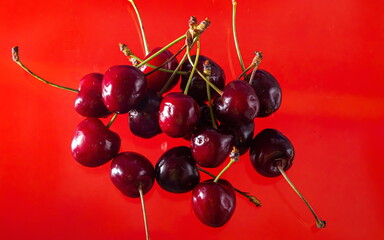 Naklejka na ściany i meble Ripe cherries on a solid background, healthy vegetarian food. Beautiful