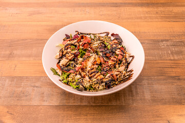 Tuscan salad with lettuce, grated tomato, serrano ham, sesame seeds and lots of balsamic vinegar