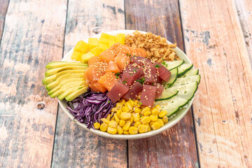 time to eat an excellent mixed poke bowl of salmon pairing, red tuna, avocado and sliced cucumber,...