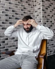 Obraz premium A man with a beard showing emotions with gestures and a face