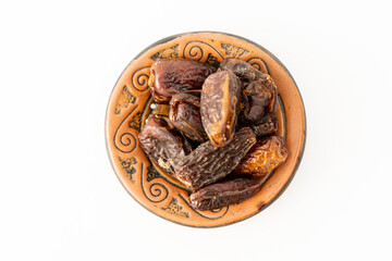 Fresh dates in a rustic plate on a white surface. Aerial view, Concept healthy and natural food