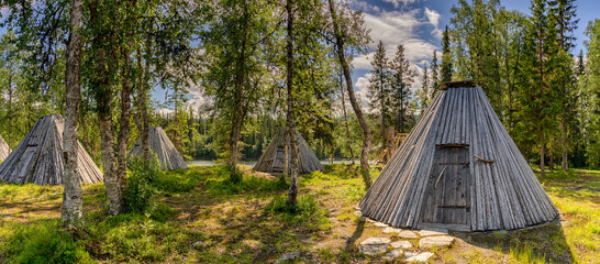 view of many historic Sami Lavvu huts or wooden tipis in Ankerede in northern Sweden