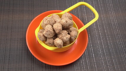 Raw soya chunks on dark background. Healthy, nutritious soybean meat, chunks isolated.Vegan food concept.