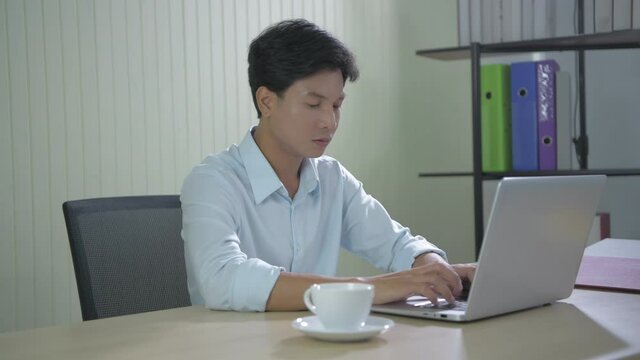 Business concept of 4k Resolution. Young Asian men are tired of working in the office.