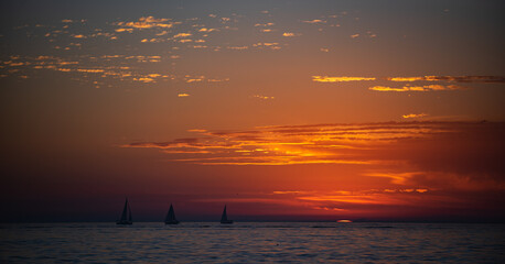 Sunset in the sea with beautiful clouds. Sunrise ocean seascape.