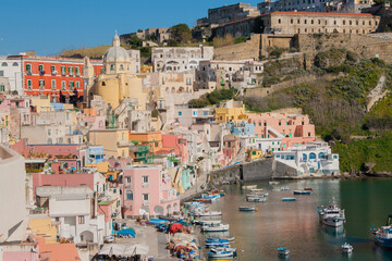 Fototapeta na wymiar View on the harbor in the lovely bay of Procida island. Beautiful island near Naples, Italy.