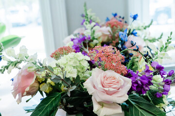 A simple bouquet of flowers including pink roses at a florist shop