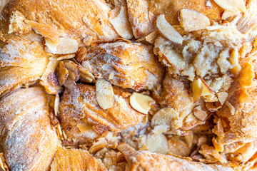 Closeup flat top lay view of danish almond kringle nut strudel pastry macro texture on baked dessert golden crust and filling