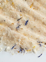 a slide of pink coarse sea salt with dried flowers for baths