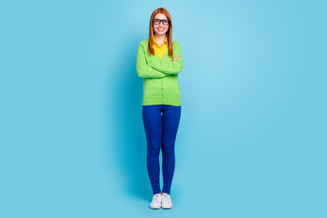 Full length body size view of attractive cheerful red-haired girl folded arms isolated over bright blue color background