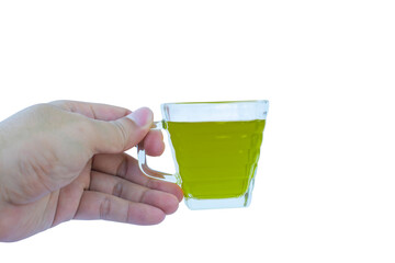 hand holding a glass of water with green water
