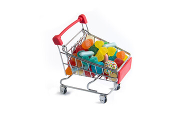 Shopping cart full of colorful tasty jelly candies isolated on white background