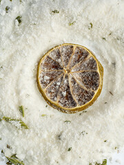 a handful of pink coarse sea salt with dried flowers and bath lime