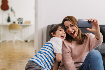 little boy enjoying time with his mom at home