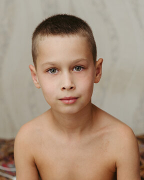 portrait of a seven year old boy with short hair