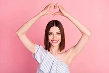 Fototapeta na wymiar Photo of romantic brunette millennial lady show heart up wear white top isolated on pink color background