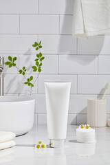 Cosmetics product and cotton towels, cottons pad with green plant on white table inside a bathroom...