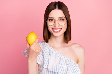 Photo of young attractive woman happy positive smile hold lemon fresh food citrus eco isolated over pink color background